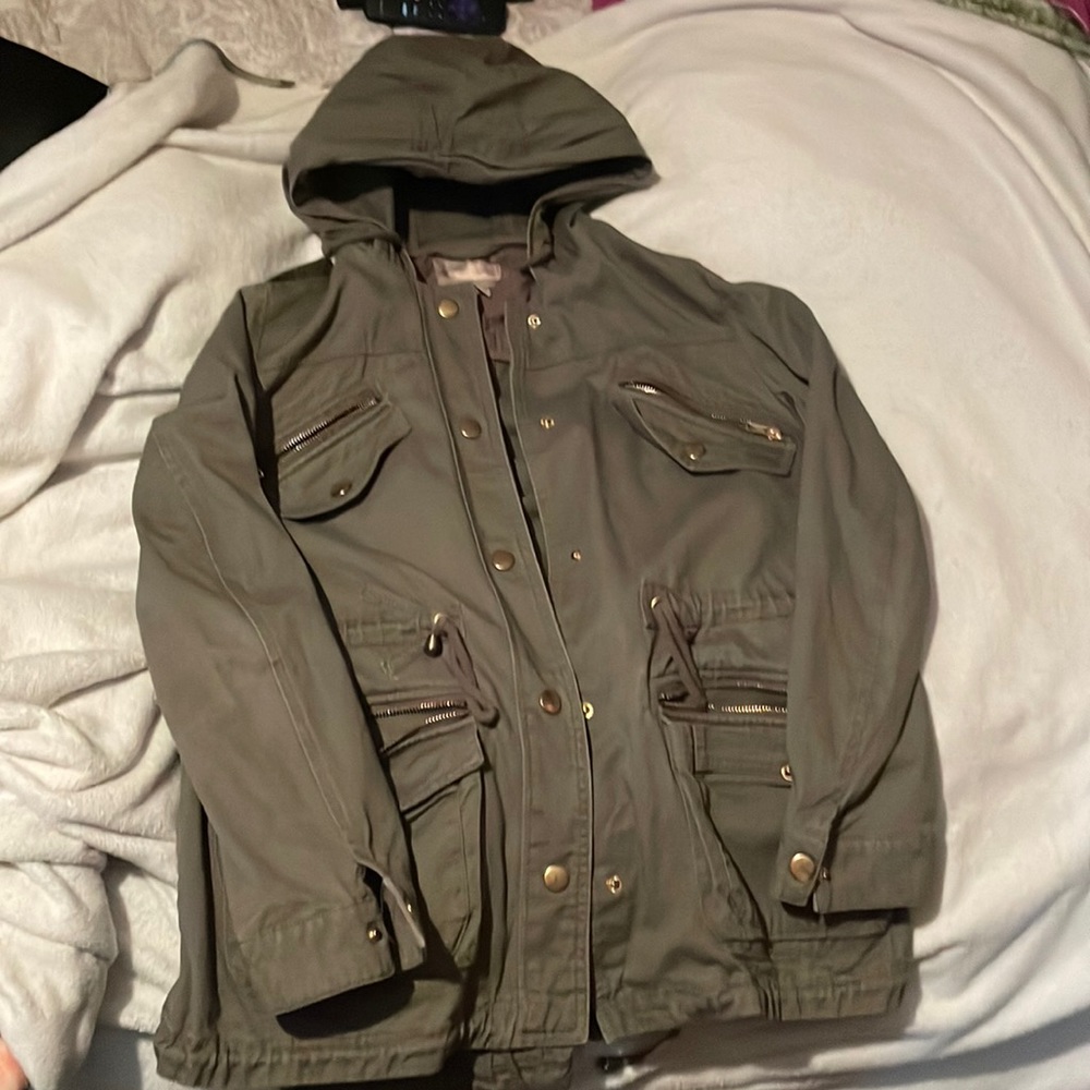 Green women’s hooded jacket with multiple pockets